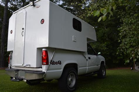 A <b>Truck</b> <b>Camper</b> is slid into place in the bed of a <b>truck</b> and then fastened onto the <b>truck</b> frame. . Slide in truck campers for sale